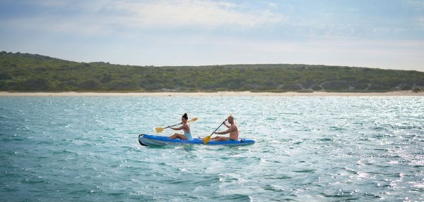 couple kayaking on sunny summer lake
