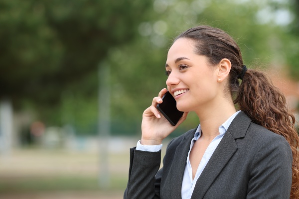 happy businesswoman talking on cell phone