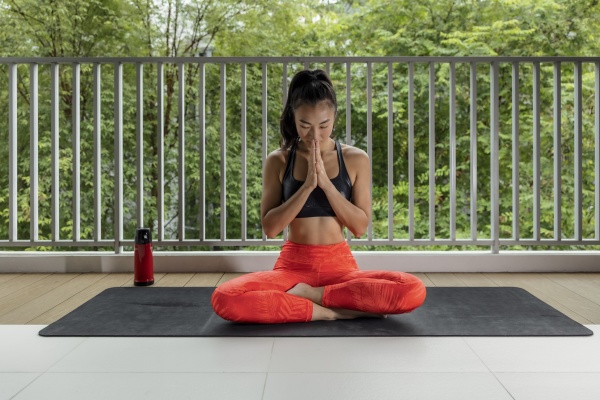 sportswoman with hands clasped meditating at