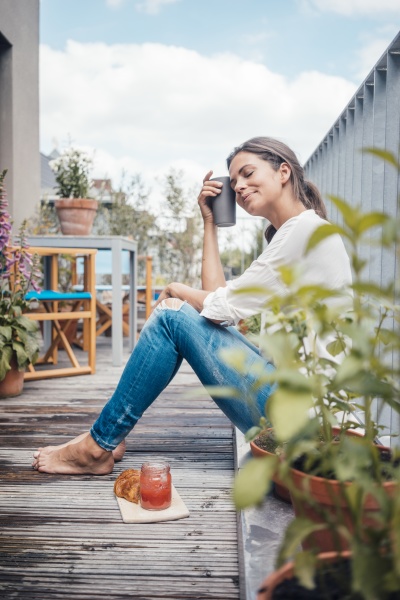 smiling woman with eyes closed holding
