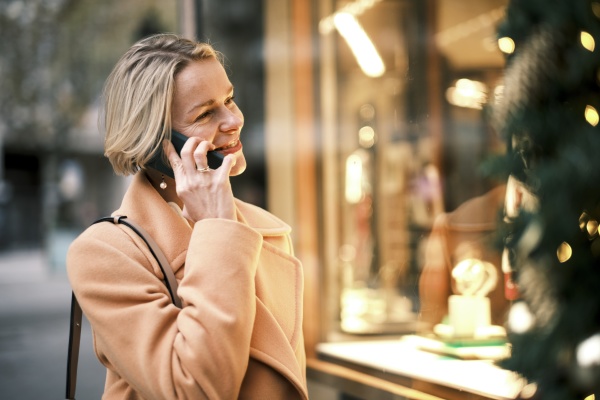 happy woman talking on phone standing