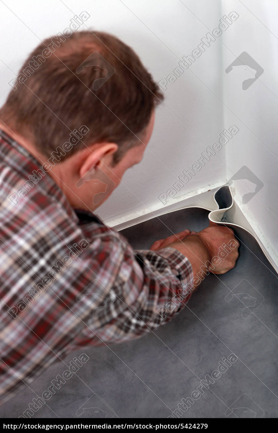 Man Pushing Linoleum Into The Corner Of A Room Royalty Free Image Panthermedia Stock Agency