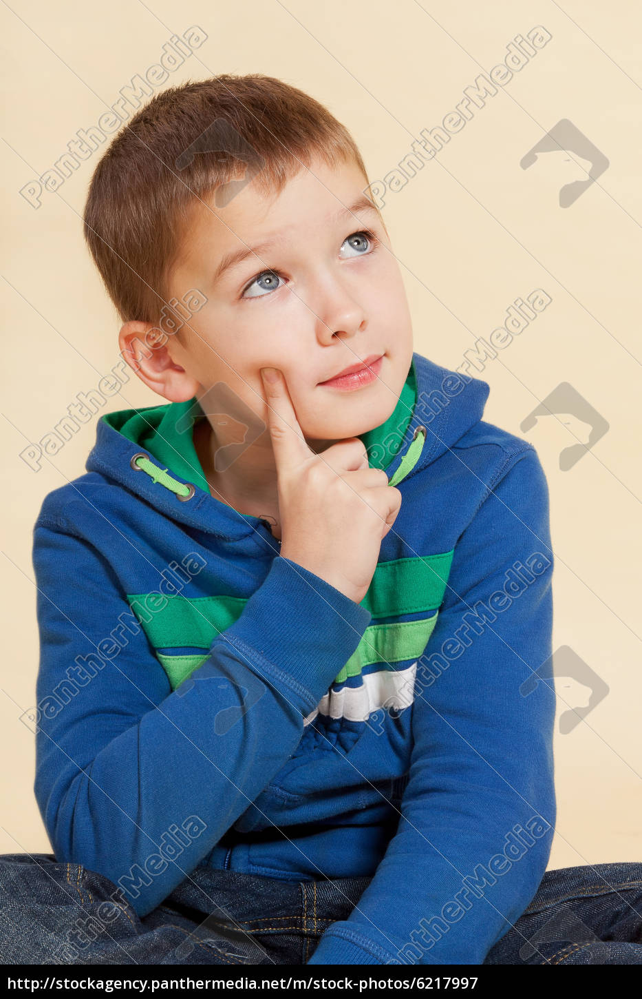 young-cute-boy-sitting-and-thinking-stock-photo-6217997