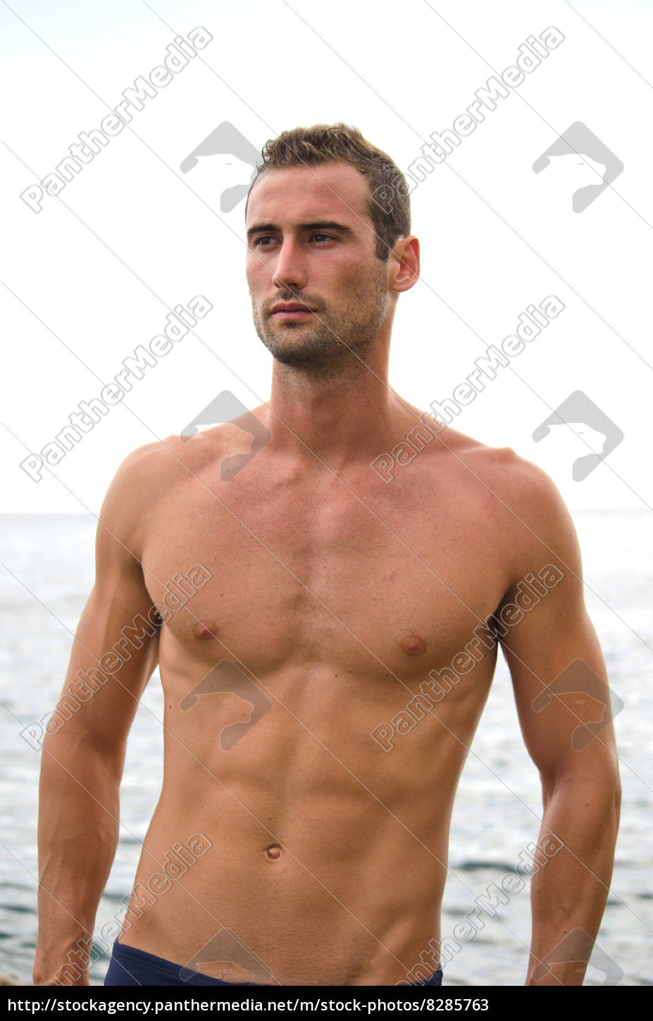 Shirtless Muscular Male Model With Sea Behind Royalty Free Image