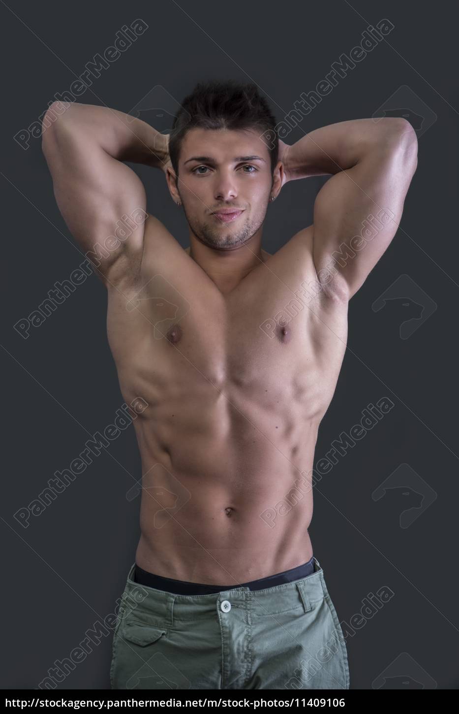 Bodybuilder Showing His Toned Biceps Stock Photo by