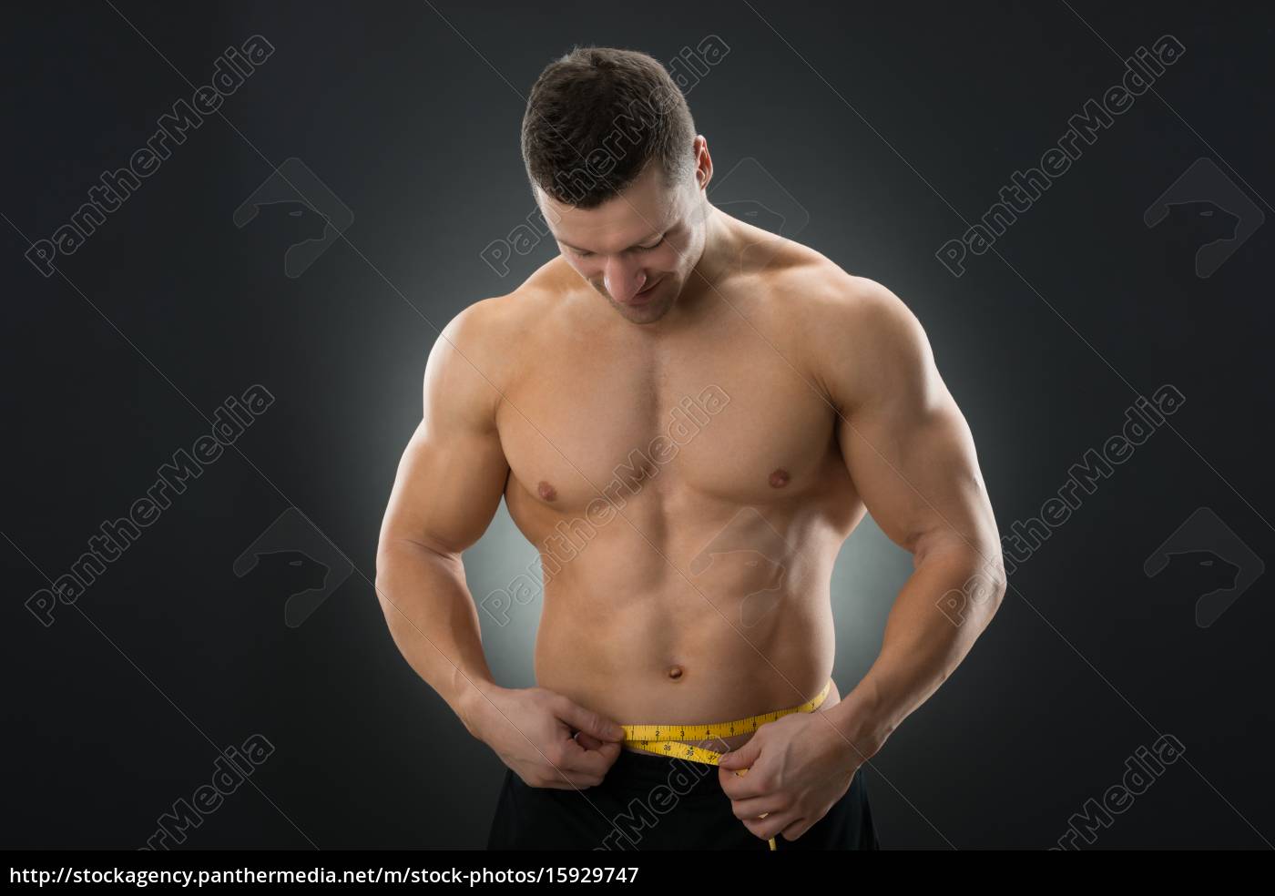 Muscular Man Measuring Waistline With Measure Tape - Stock Photo ...