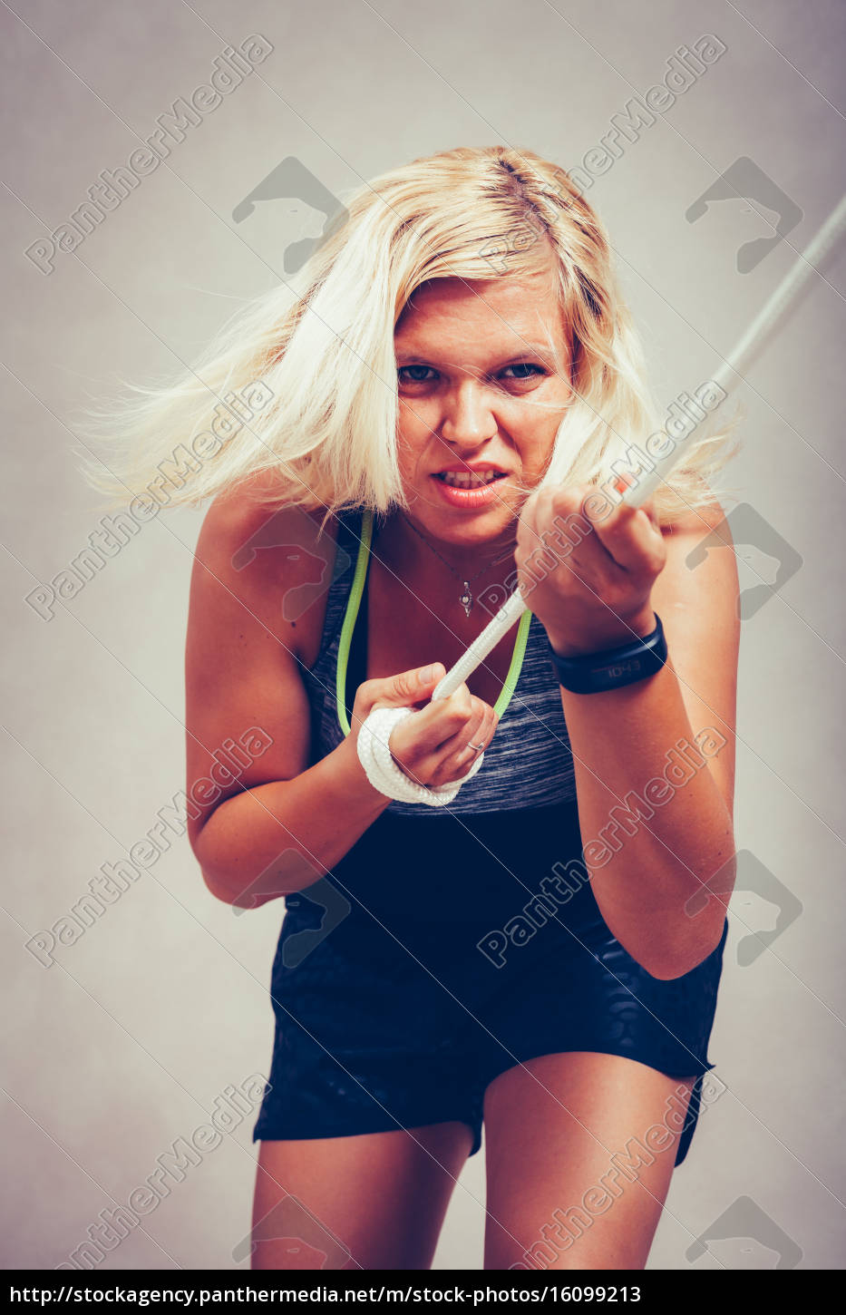 Strong sporty woman pulling rope - Stock Photo #16099213