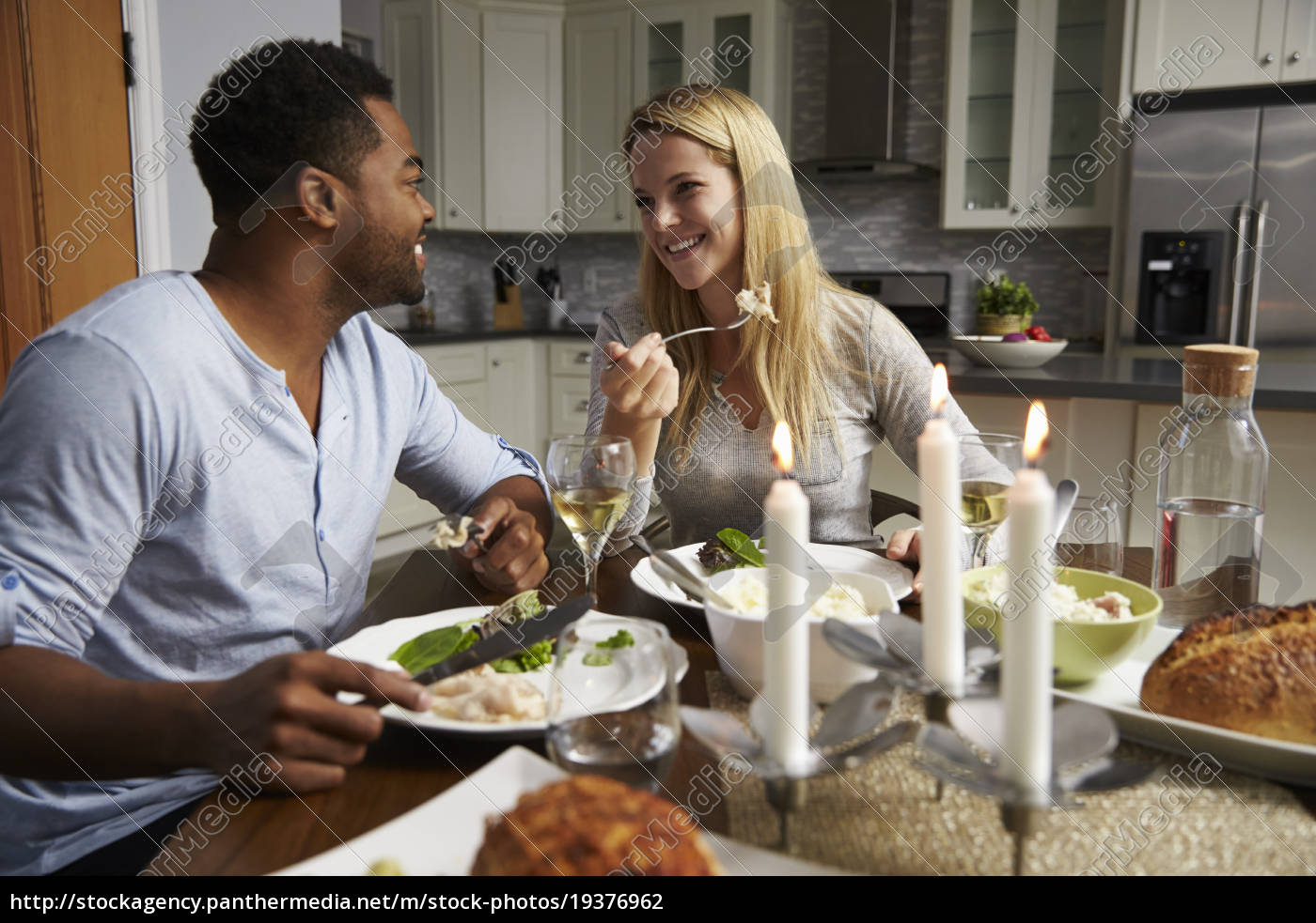 Romantic Mixed Race Couple Eating Evening Meal In Stock Image
