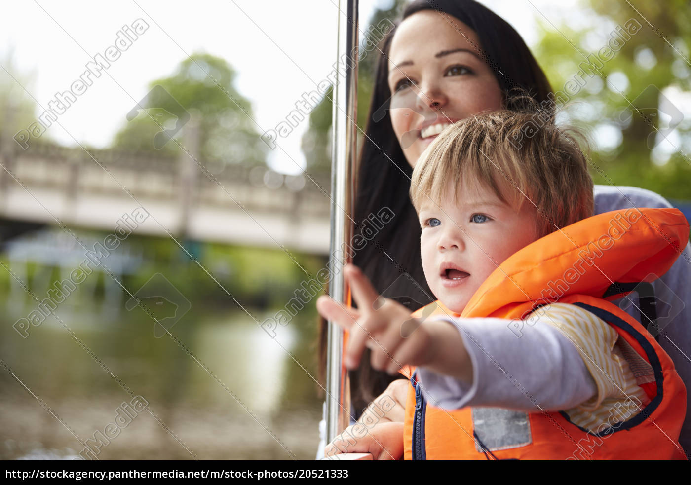 Mother And Son Enjoying Day Out In Boat On River Stock Photo