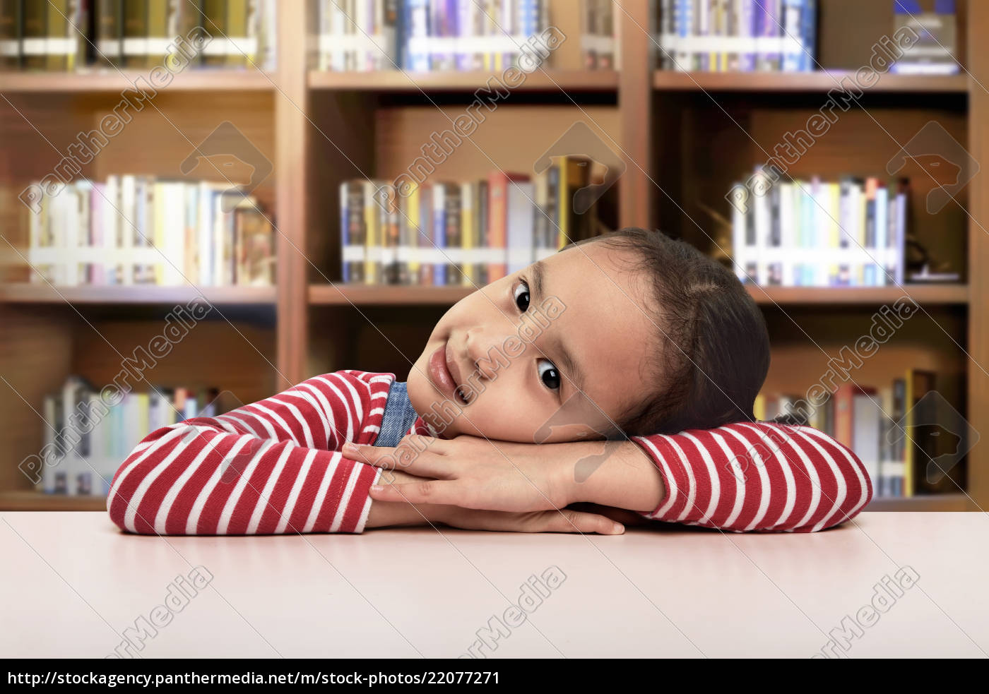 Beautiful Asian Little Girl Lying Down On The Desk Stock Photo