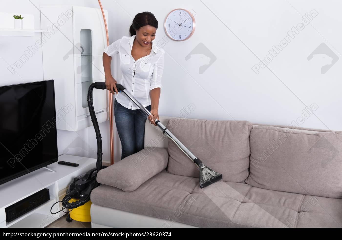 African Woman Cleaning Sofa With Vacuum, How To Clean Sofa At Home With Vacuum Cleaner