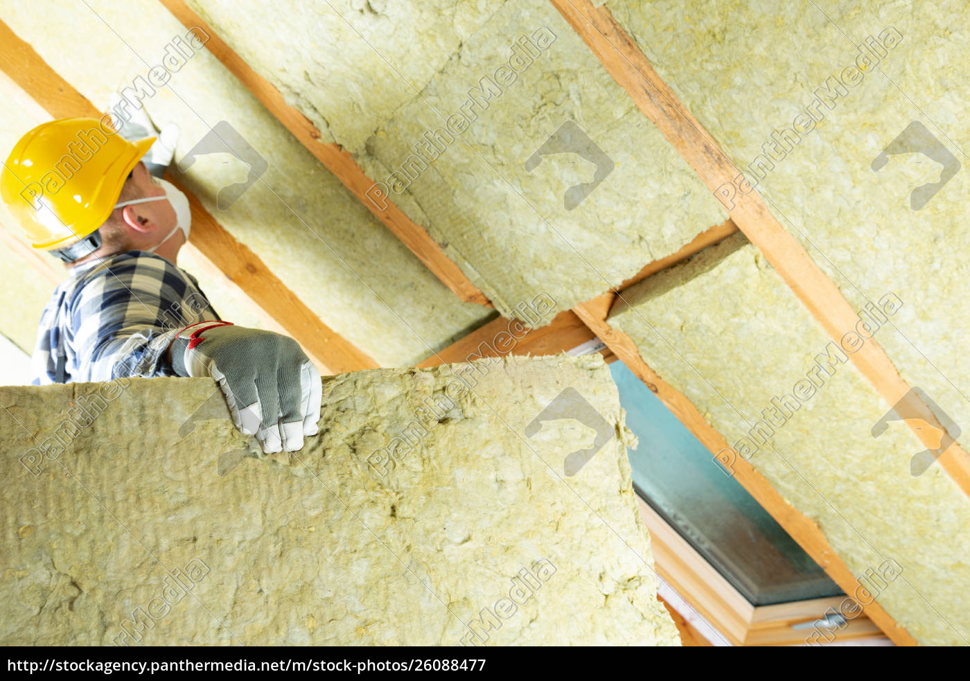 Man Installing Thermal Roof Insulation Layer Using Royalty